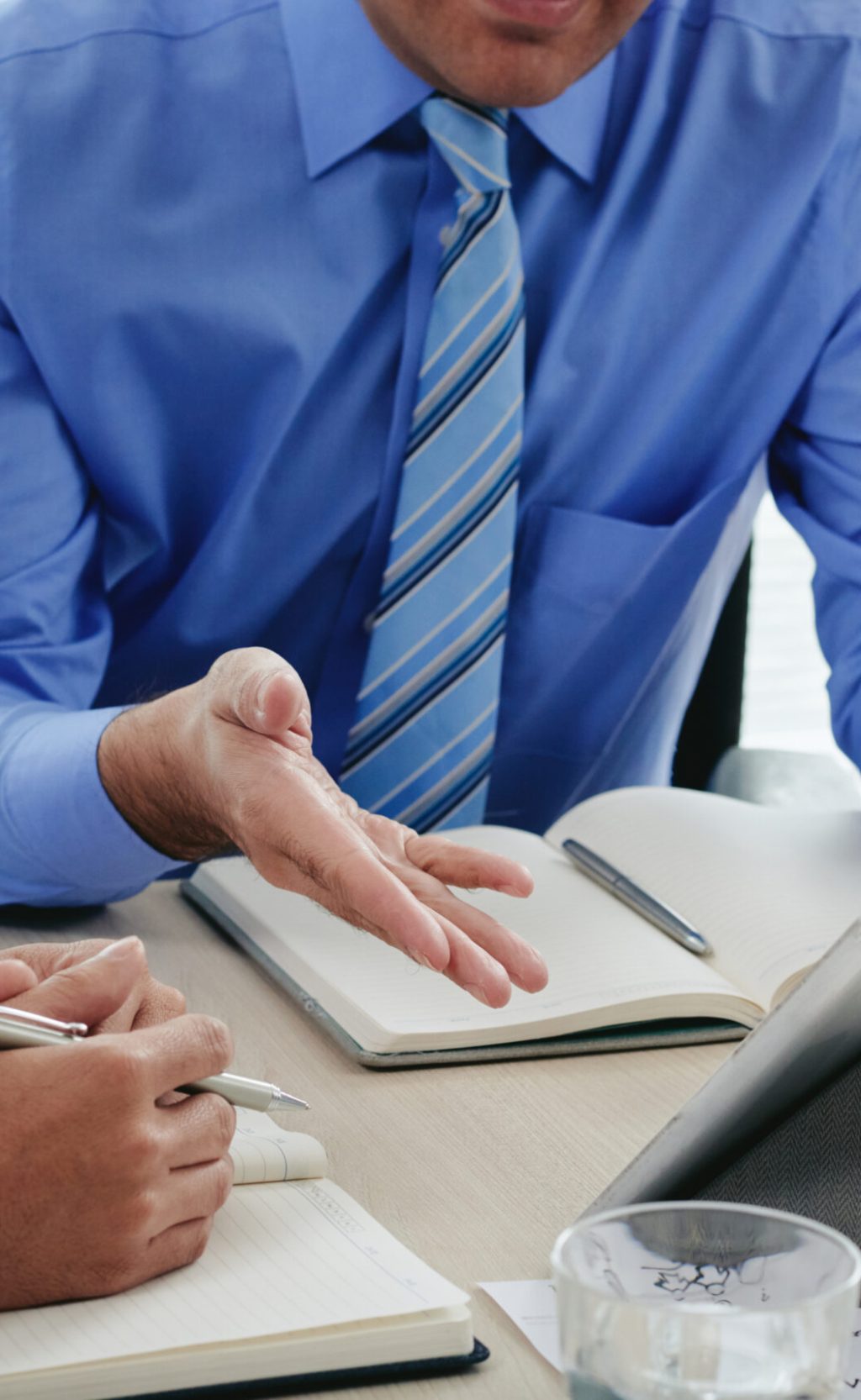 Cropped image of business people dicussing information on digital tablet